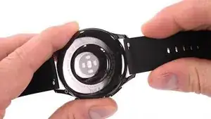 User your fingernail to pull the small metal pin on each wrist band towards the inside. This unlocks the wrist bands from the body of the watch.