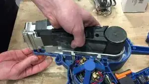 Unscrew the orange wheel to be able to lift it.