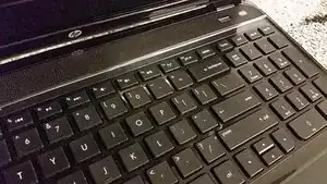 Use your fingernails to get between the palmrest and the keyboard, and pry the keyboard out.