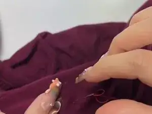 Sew the loop to the shirt starting from the inside with tight stitches.