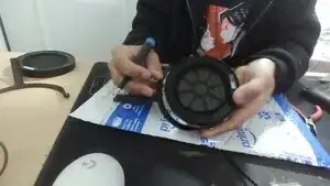 This is simple just unscrew the 6 Screws on the surrounding metal plate and remove the plate. just be generally careful around the mesh screen of the driver