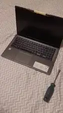 Flip the laptop upright.