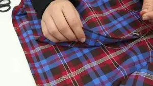 Bring the needle back to the outside of the fabric and wrap the thread around the button several times to create a “button stem” that will create some distance between the button and the fabric.