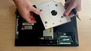 Remove the back bracket from the back of the optical drive, and the faceplate and instal the both of them in the new DVD Drive.