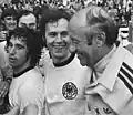 Beckenbauer mit Gerd Müller und Bundestrainer Helmut Schön als Weltmeister im Jahr 1974