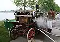 Feuerwehrleute aus Österreich zeigen einen alten Löschwagen, der mit Dampf funktioniert.