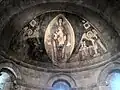 Ein Wandbild aus Spanien: groß in der Mitte ist Maria mit dem kleinen Jesus
