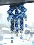 Die Hand der Fatima hat ein Auge. Dieser „Glücksbringer“ fährt in einem Auto in Tunesien mit.