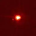 Der Zwergplanet Eris. Weiter links unten, nahe bei Eris, sein Satelliten Dysnomia.