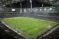 In der Volkswagen Arena. Hier spielt Wolfsburg gerade gegen den FC Bayern.