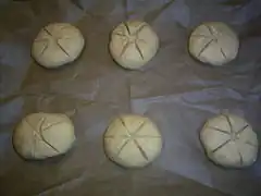 Die Brötchen-Teiglinge vor dem Backen oberseitig ca. 5 mm tief, sternförmig einschneiden.