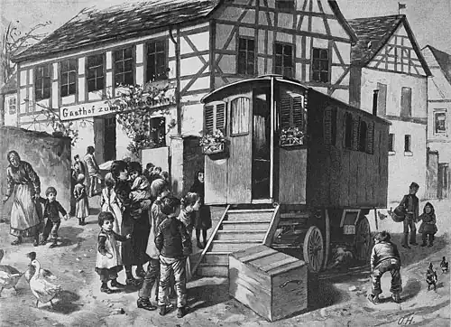 Die Gartenlaube (1893) b 885.jpg Vor dem Wagen der Puppenspieler