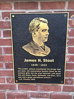 A black and gold plaque of James Stout that says how he'll always be remembered.