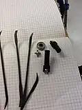 Disassembled U-joint with hand files.